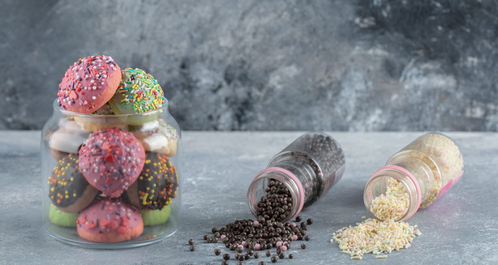 Colorful candies with sprinkles in jars related to what candy is gluten free.